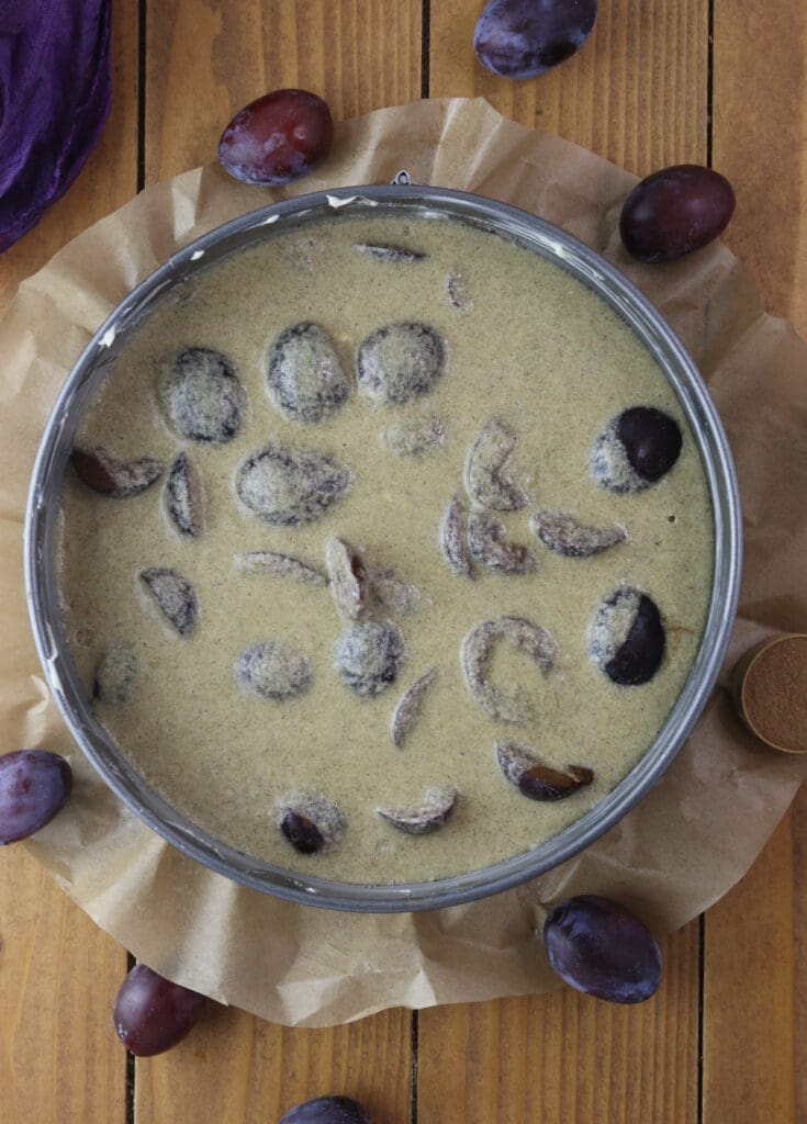 Pouring the batter over the plums before baking the clafoutis